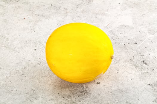 Sweet juicy whole yellow melon photo
