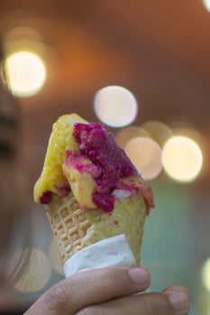 Close up hand of a person holding an ice cream cone with blurred background photo