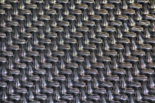 Black plastic basketwork pattern in close-up. photo