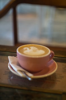 A cup of coffee latte with froth art on the table photo