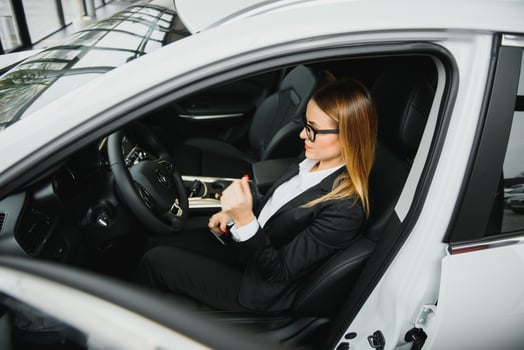 business woman buys a new car at a car dealership photo