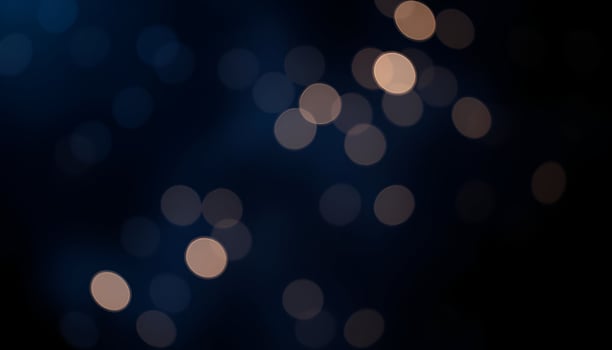 a blurry image of a dark background with lights photo