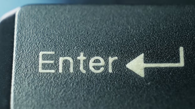 Close-Up View of Enter Key on Computer Keyboard With Clear Directional Arrow photo