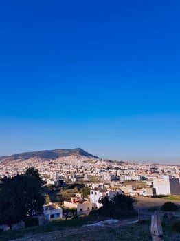 Cityscape under a blue sky, quiet beauty of urban life with this amazing wide shot of the city photo