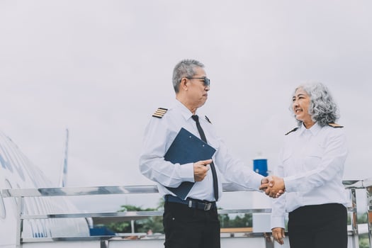 Professional pilot woman in uniform has teamwork meeting for success flight in aviation business. Young female captain instructor sitting in office and working or training commercial airline crew. photo