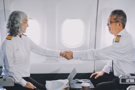 Professional pilot woman in uniform has teamwork meeting for success flight in aviation business. Young female captain instructor sitting in office and working or training commercial airline crew. photo
