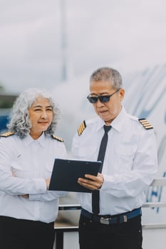 Professional pilot woman in uniform has teamwork meeting for success flight in aviation business. Young female captain instructor sitting in office and working or training commercial airline crew. photo