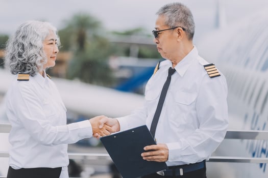 Professional pilot woman in uniform has teamwork meeting for success flight in aviation business. Young female captain instructor sitting in office and working or training commercial airline crew. photo