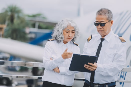 Professional pilot woman in uniform has teamwork meeting for success flight in aviation business. Young female captain instructor sitting in office and working or training commercial airline crew. photo