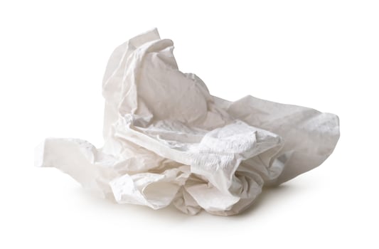 Side view of white screwed or crumpled tissue paper ball after use isolated on white background with clipping path photo