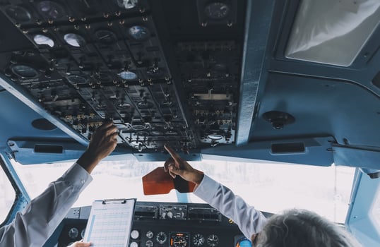 Professional pilot woman in uniform has teamwork meeting for success flight in aviation business. Young female captain instructor sitting in office and working or training commercial airline crew. photo
