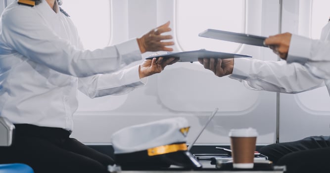 Professional pilot woman in uniform has teamwork meeting for success flight in aviation business. Young female captain instructor sitting in office and working or training commercial airline crew. photo