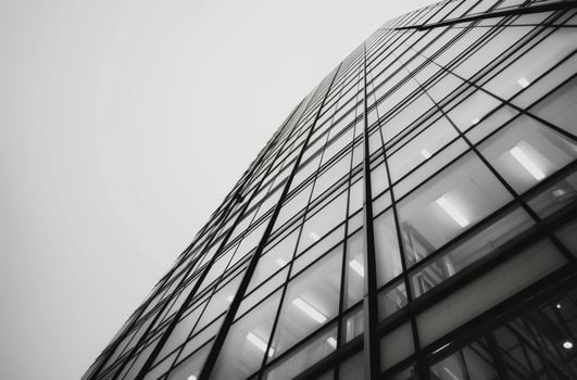 Modern Glass Building Reaching Sky Under Cloudy Sky photo