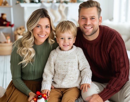 Family Portrait Taken Indoors During Holiday Season With a Young Child and Warm Smiles photo