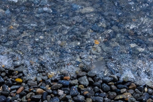 Kara-Dag, a round sea-rolled pebble from a volcanic rock on a pebble beach, Crimea photo