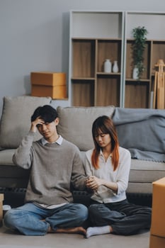 Asian Female discussing new project with male colleague. Young woman talking with young Asian man with financial on sofa in home office photo