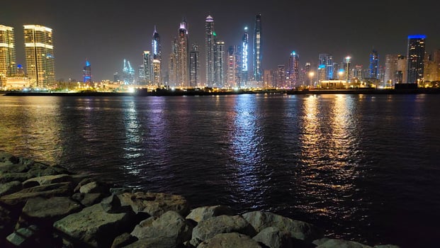 palm jumeirah cityscape with river in the night view photo