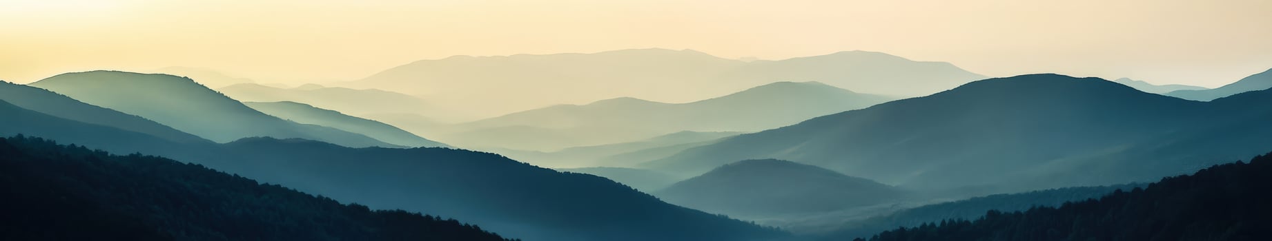 Foggy mountain landscape at dusk with layered hills in the distance photo