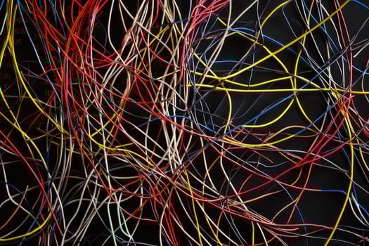 A tangled and chaotic arrangement of thin wires creating an intricate texture background photo
