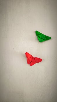 Two red and green origami butterflies photo