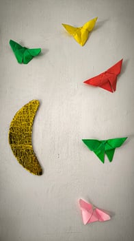 A wall with a yellow and green butterfly photo
