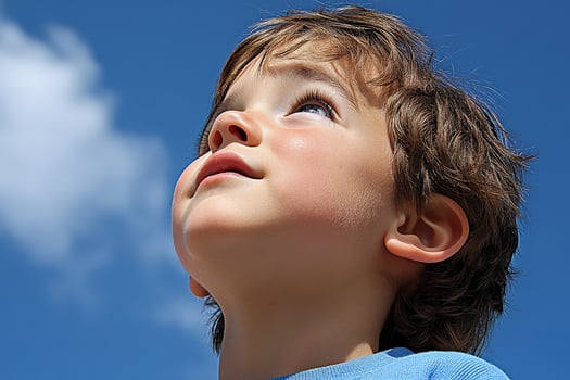 High school boy gazing at the clear blue sky on a sunny afternoon photo