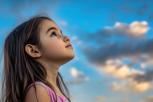 High school girl gazing at the sky during a bright afternoon photo