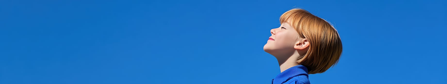 High school girl gazes up at a clear blue sky during midday photo
