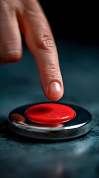 Finger Pressing a Red Panic Button. Crisis Management, Immediate Alert, High-Stress Moment. photo