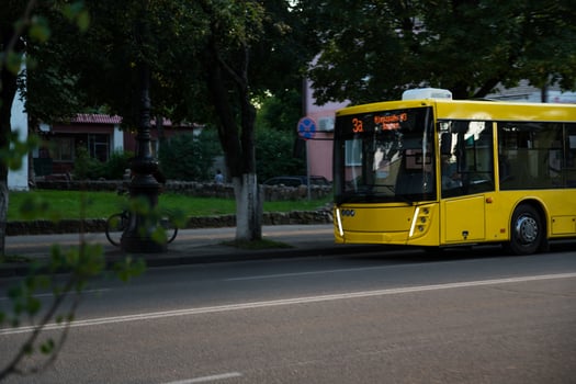 Yellow, city bus in the evening in the city photo