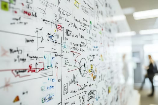 A vibrant array of sketches and notes fills the office wall, capturing ideas in a collaborative brainstorming session. photo