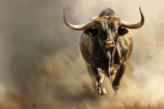 Powerful bull charging forward through dusty landscape photo