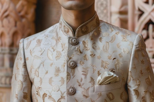 Groom wearing embroidered cream sherwani posing before wedding ceremony photo