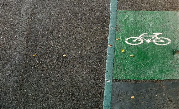 A bike lane is shown on a road with a green stripe. top view. high angle photo