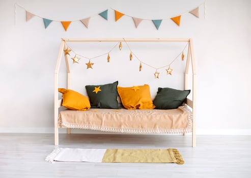 Childrens room with baby Montessori bed in foreground, minimalist kids bedroom design photo