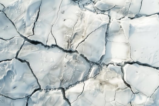 Aerial view of cracked ice texture on frozen surface photo