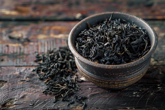 Dried loose leaf black tea in ceramic bowl photo