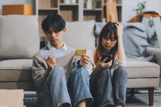 Worried annoyed young husband wife using phone credit card dissatisfied with interrupted wifi internet connection slow bad app work. Angry family couple bank clients unable to pay online check balance photo