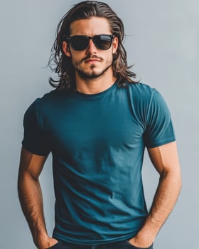 A handsome model confidently wears a blank t-shirt in an urban backdrop photo