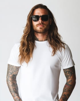 Model confidently presents a blank t-shirt against a simple backdrop photo
