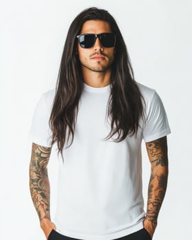Handsome model with tattoos wears a blank t-shirt in a chic environment photo