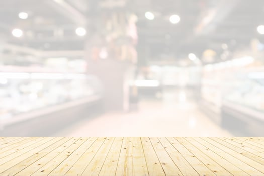 Empty wood table top with supermarket blurred background for product display photo