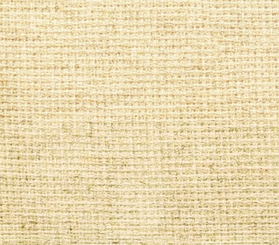 A beige fabric background with a woven pattern photo