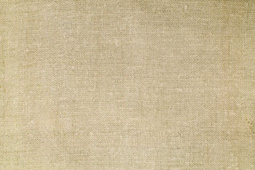 Natural Linen Material Textile Canvas Fabric Texture Background Close-up Detail of Fabric Natural Color Hemp Material Pattern Design Wallpaper. Can be Used as Background or For Graphic Design photo