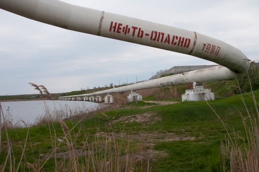 The inscription on the pipe is -oil-dangerous, Ecological problem. Pipe for pumping oil and gas. Ukraine, mart 2017. photo