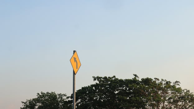 traffic sign sign turn left on a yellow background photo
