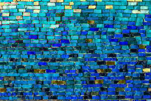 texture of multi-colored stones. Background from vintage mosaic on the wall. photo