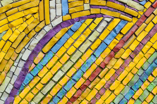 texture of multi-colored stones. Background from vintage mosaic on the wall. photo