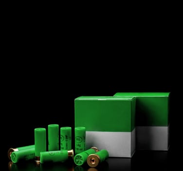 Shotgun cartridges. Ammunition for smooth-bore weapons. Boxes of cartridges on a black back photo