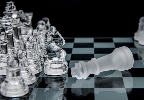 glass chess. defeated king on a chessboard. photo